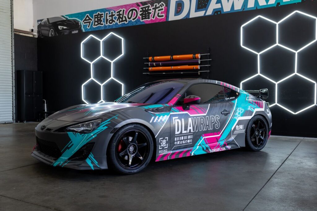pexels photo 36045954 Dynamic photo of a sleek sports car with colorful custom vinyl wrap by DLA Wraps in a shop setting.